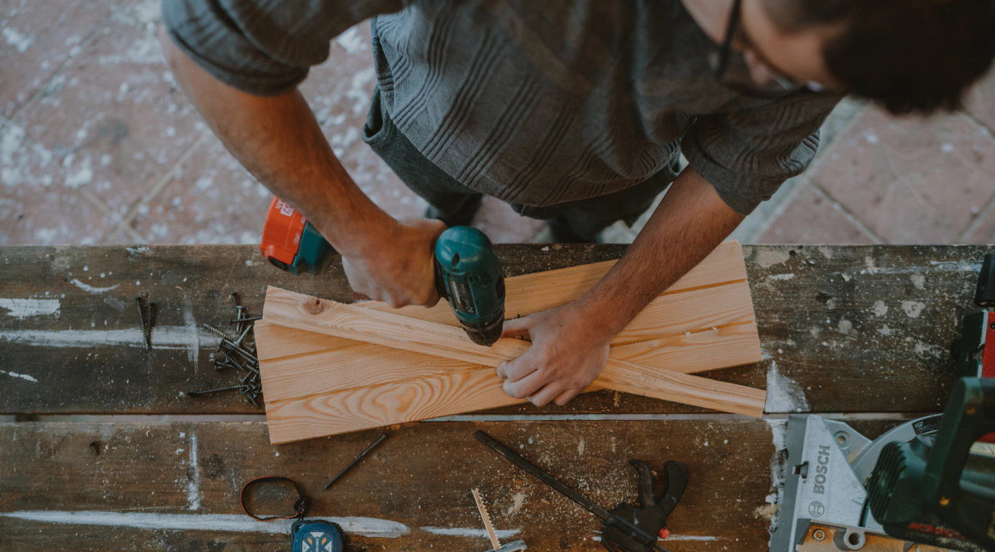 handyman working on a wooden plank